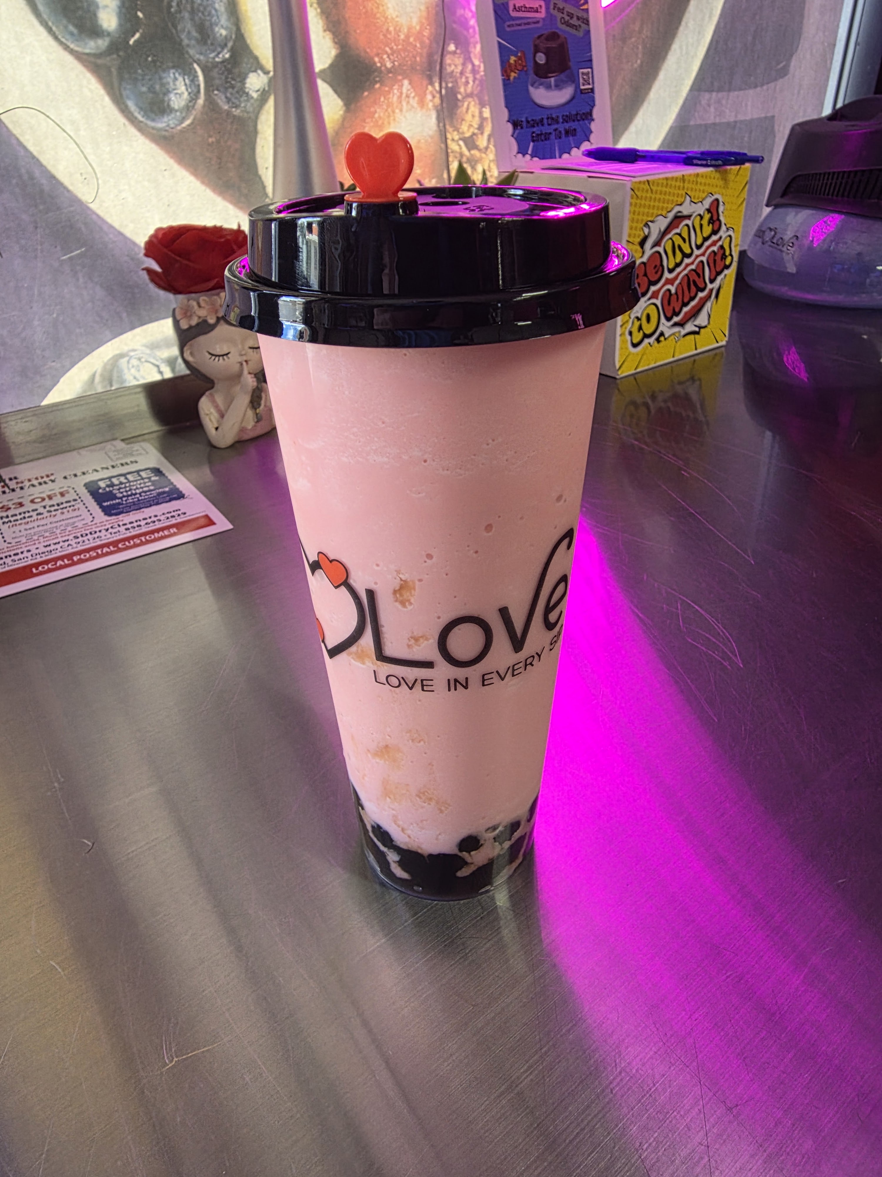 Strawberry milk tea with boba in a Love in Every Sip cup